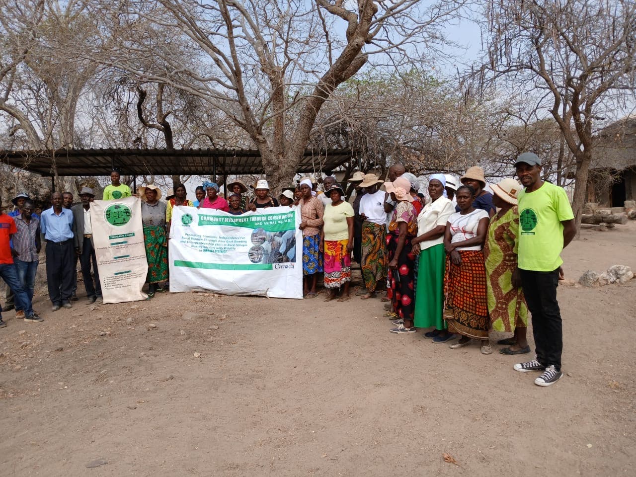 Community members gathered with programme banners