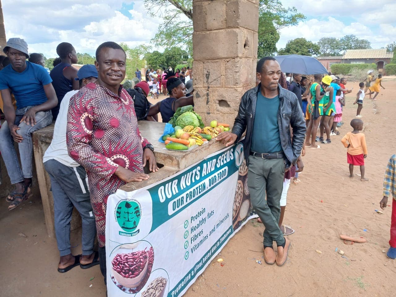 Participants displaying fruit and produce at an event