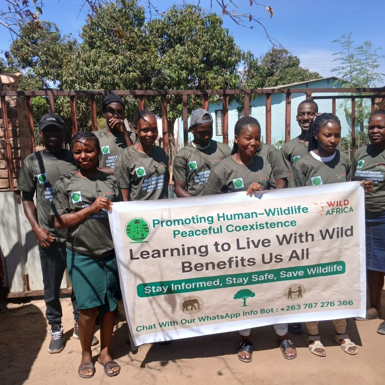 Young people holding a human-wildlife coexistence banner